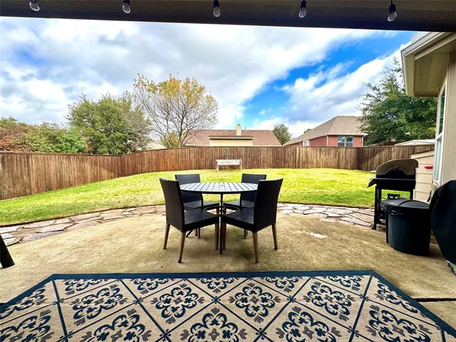 a view of a patio with a table chairs and a table