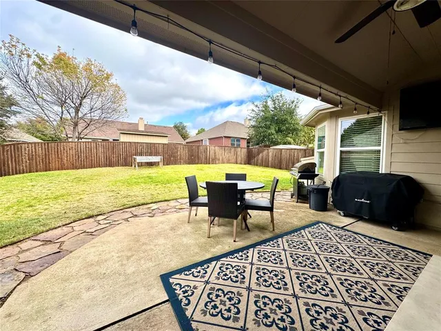 a view of a swimming pool with a table and chairs