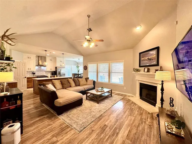 a living room with furniture fireplace and flat screen tv