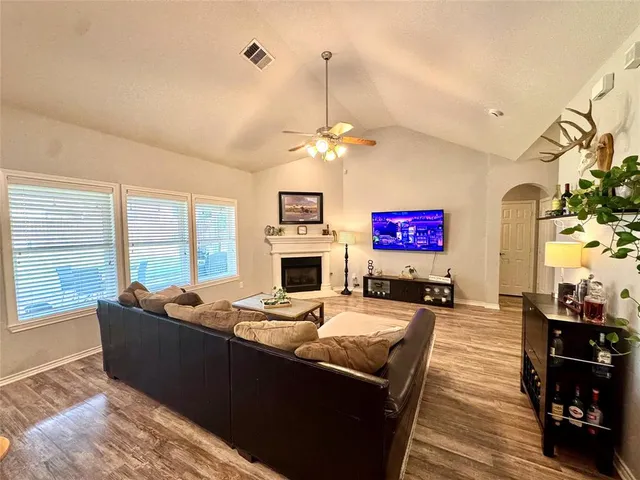 a living room with fireplace furniture and a flat screen tv