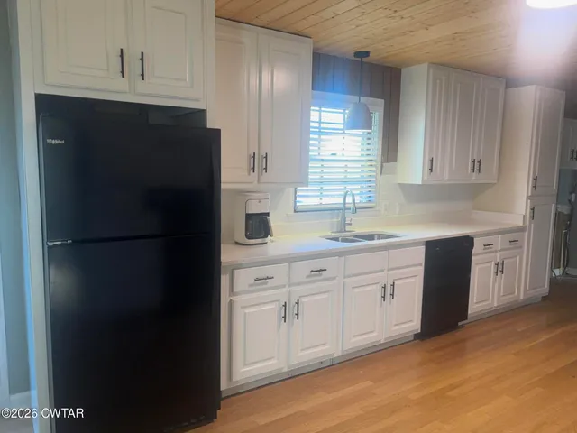 a kitchen with granite countertop cabinets stainless steel appliances and a sink