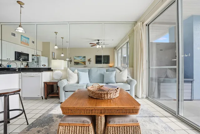 a very nice looking living room with a large window and kitchen view