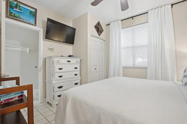 a living room with furniture a flat screen tv and a large window