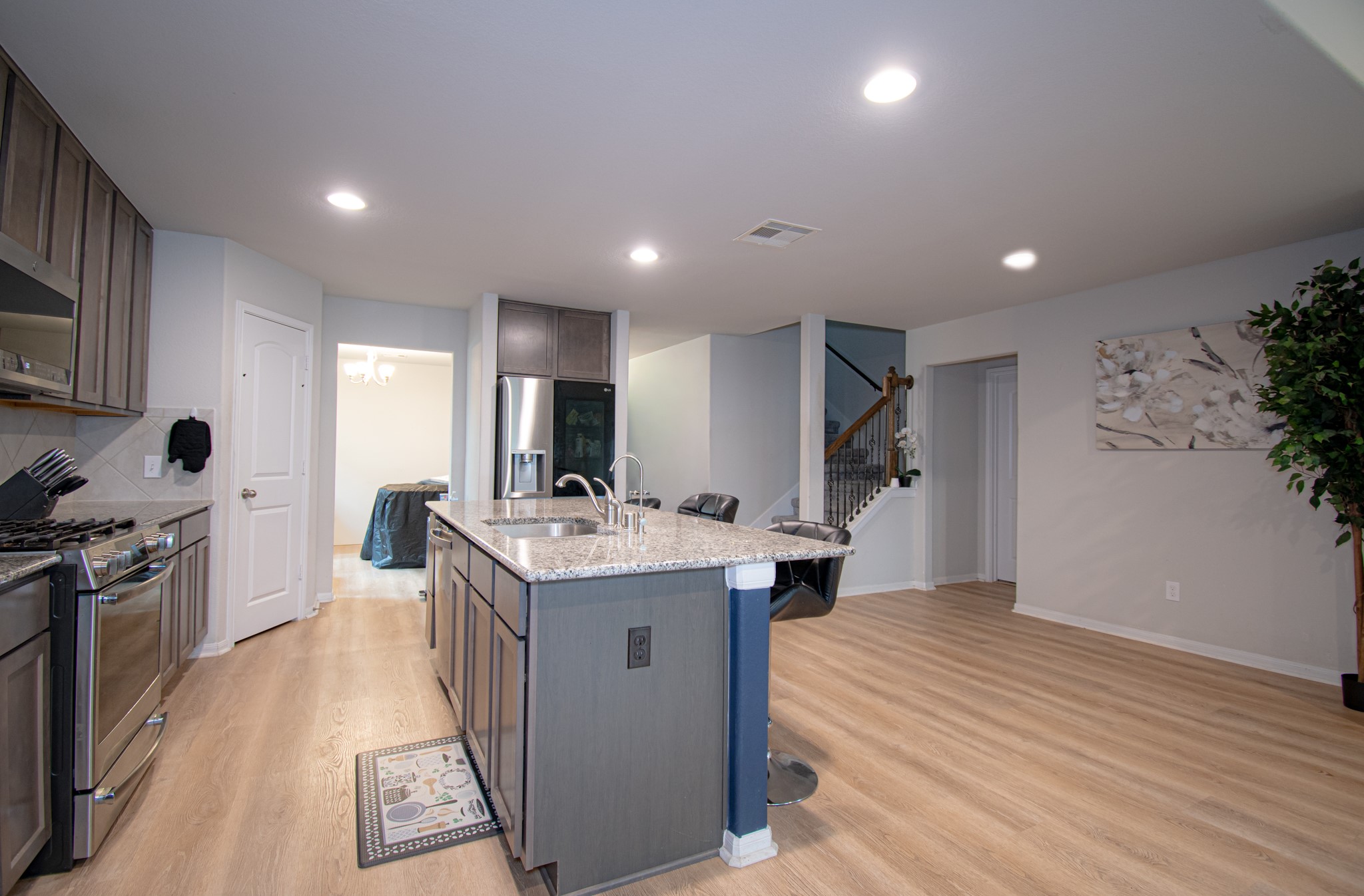 2642 Ridgeback Drive Rosenberg, TX 77471 - Photo 5 of 13 a kitchen with kitchen island a sink stove and wooden floor