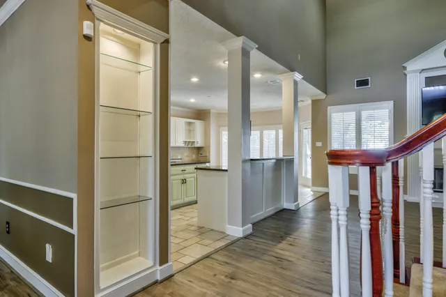 a large kitchen with kitchen island granite countertop a large window and a sink