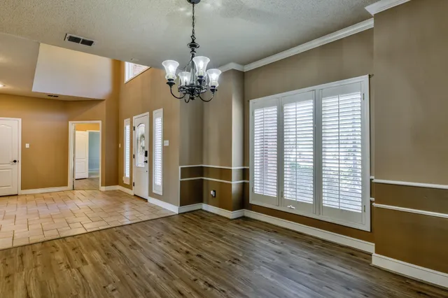 a kitchen with cabinets appliances and a window