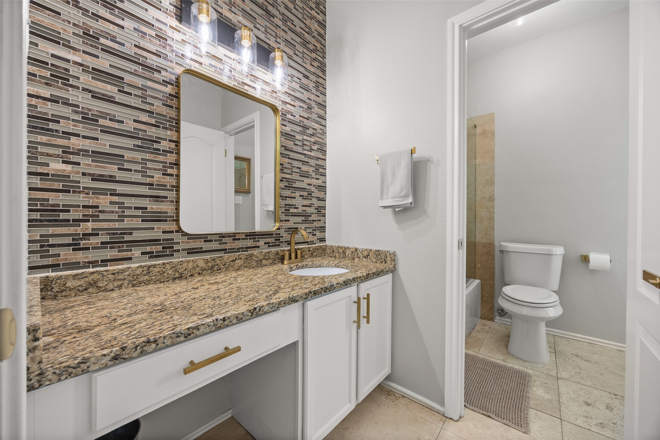 8610 Axis Drive Austin, TX 78749 - Photo 24 of 29 a bathroom with a granite countertop sink and a mirror