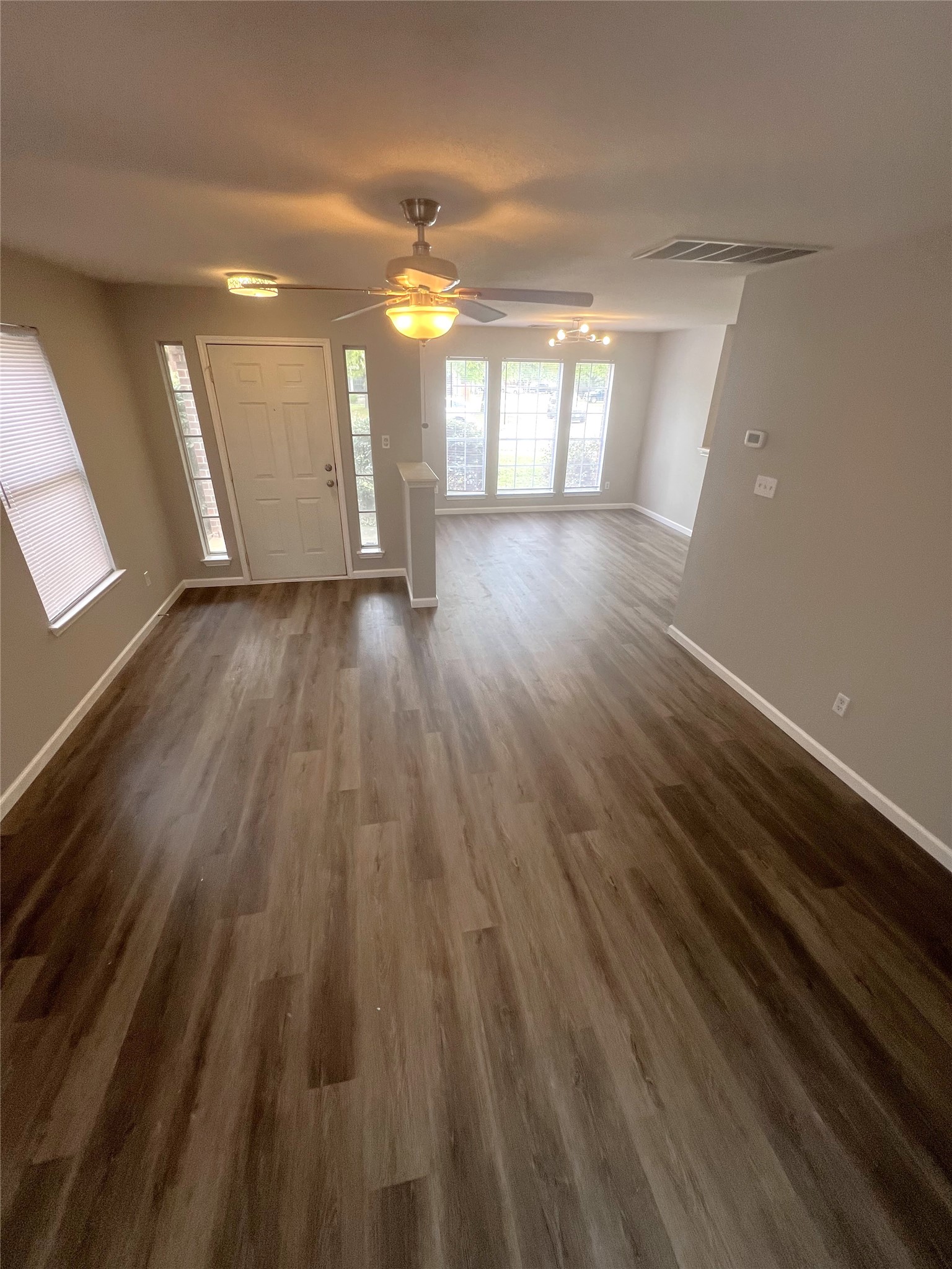 15601 Valerie's Cove Pflugerville, TX 78660 - Photo 4 of 10 Entrance foyer with ceiling fan and dark wood-style flooring