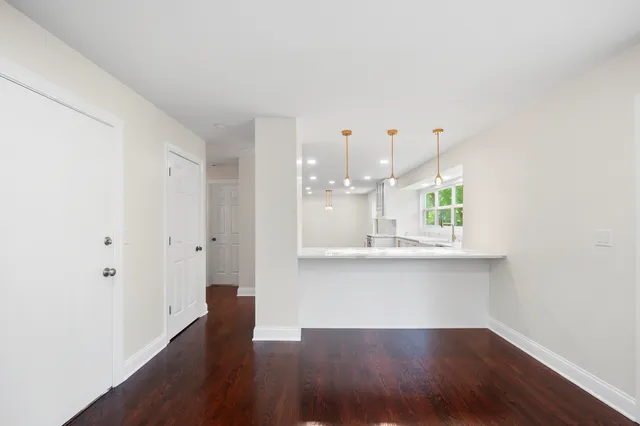 a view of kitchen with wooden floor and window
