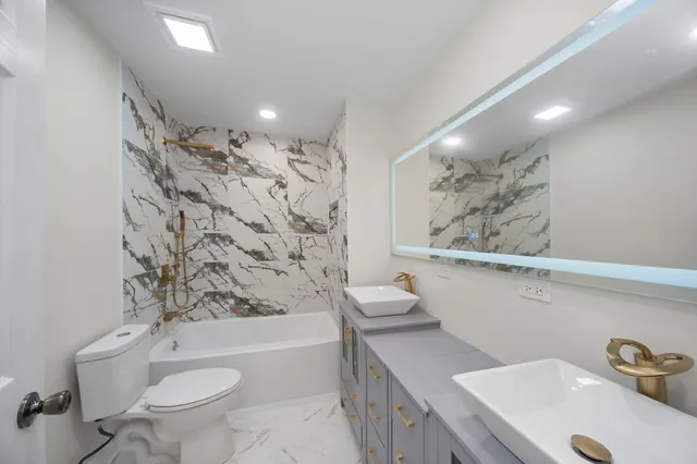 a bathroom with a sink a toilet and a bathtub