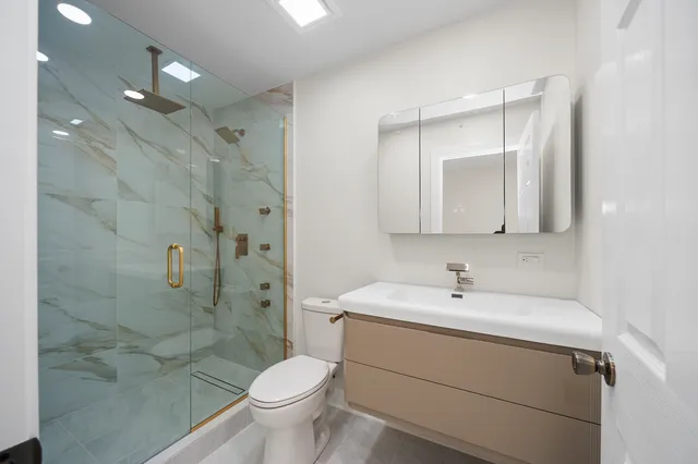 a bathroom with a sink toilet and shower