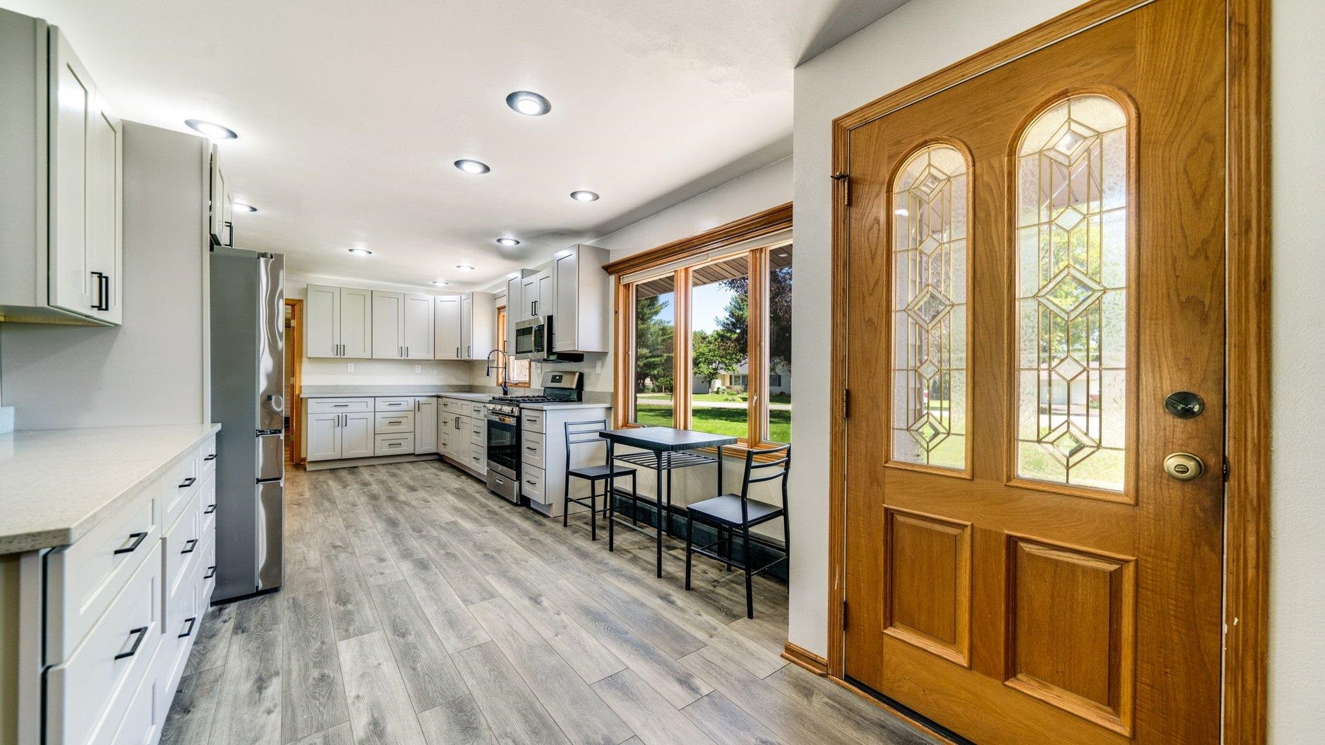313 West Margaret Fuller Road Oregon, IL 61061 - Photo 3 of 46 a view of a kitchen with kitchen island wooden floors and stainless steel appliances