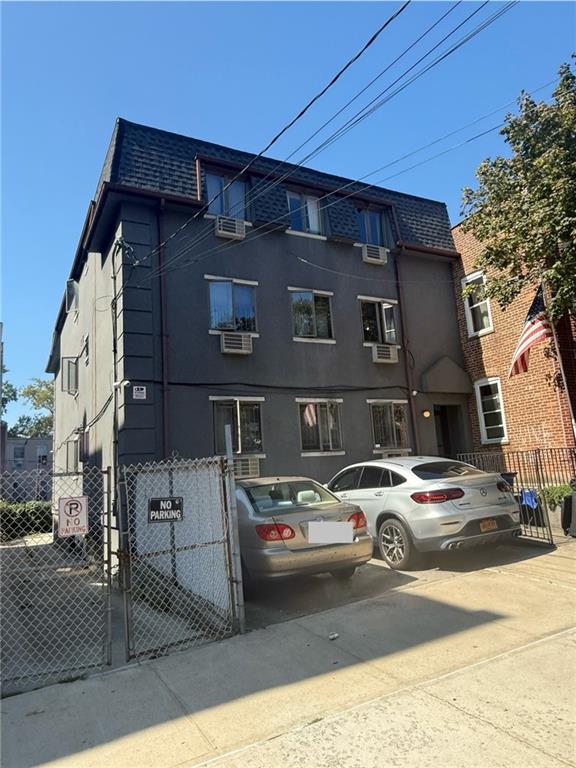 1348 63rd Street, Unit 5 Brooklyn, NY 11219 - Photo 1 of 10 a front view of a building with parking space