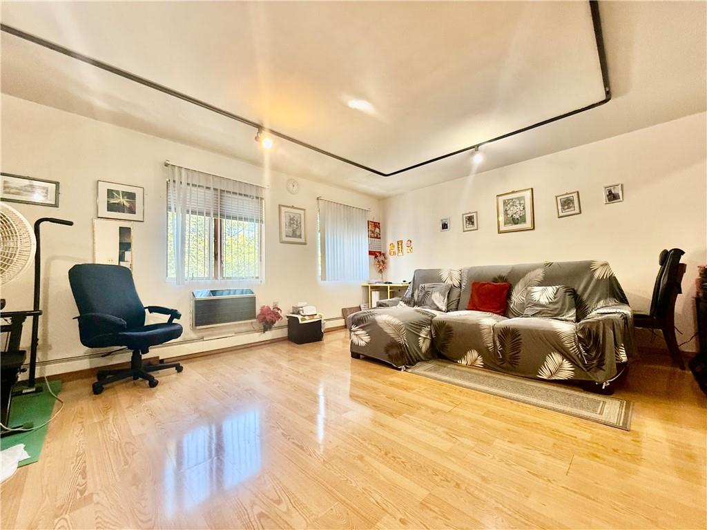 1348 63rd Street, Unit 5 Brooklyn, NY 11219 - Photo 2 of 10 a living room with furniture and a flat screen tv