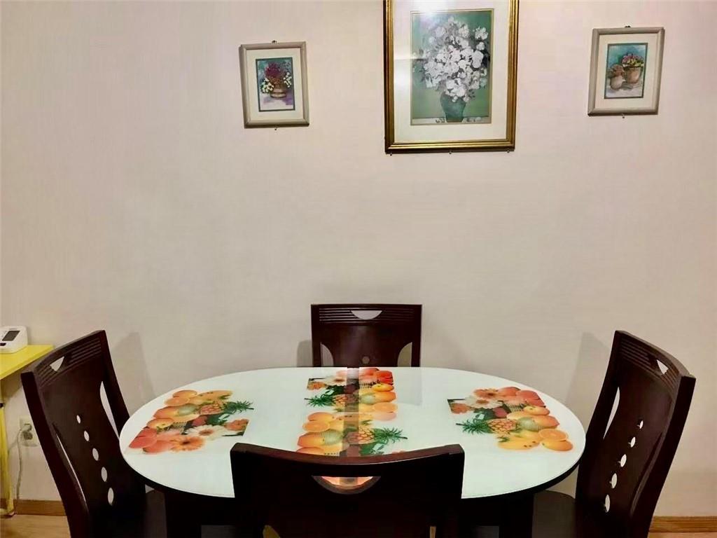 1348 63rd Street, Unit 5 Brooklyn, NY 11219 - Photo 4 of 10 a view of a dining room with table and lounge chair