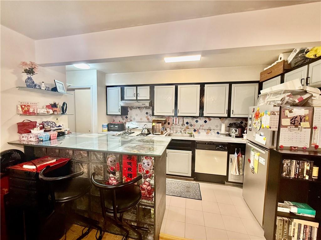 1348 63rd Street, Unit 5 Brooklyn, NY 11219 - Photo 5 of 10 a living room with stainless steel appliances kitchen island granite countertop furniture and a dining table