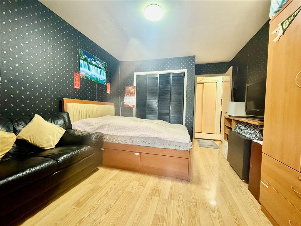 1348 63rd Street, Unit 5 Brooklyn, NY 11219 - Photo 6 of 10 a living room with granite countertop furniture and a flat screen tv