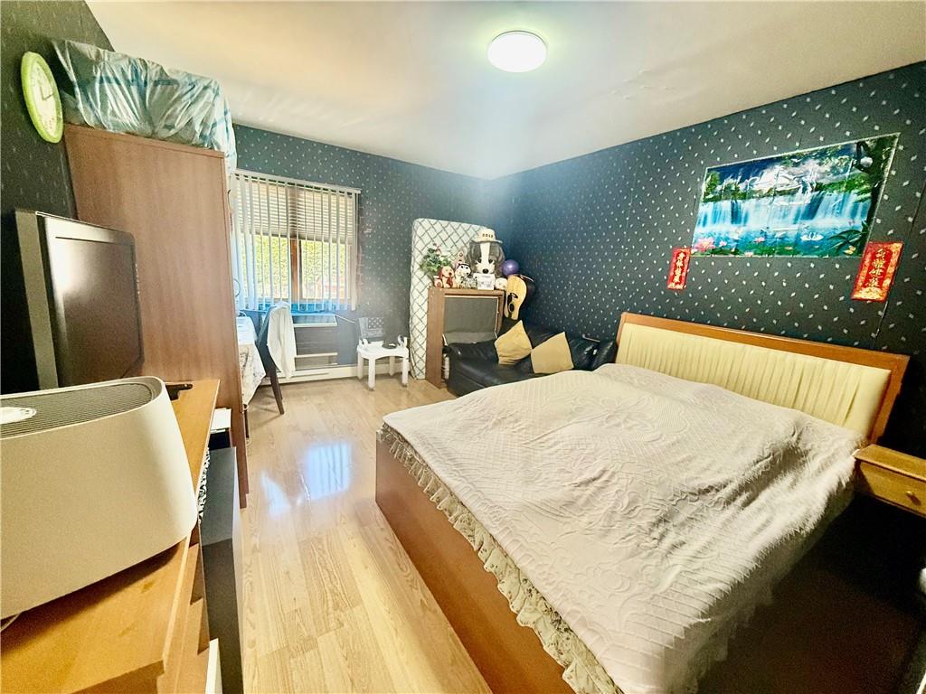 1348 63rd Street, Unit 5 Brooklyn, NY 11219 - Photo 7 of 10 a bedroom with a bed and a flat screen tv