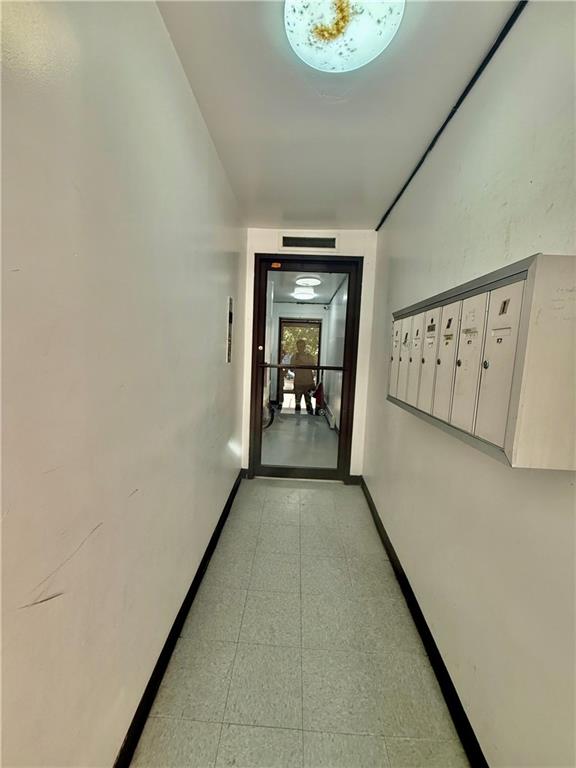 1348 63rd Street, Unit 5 Brooklyn, NY 11219 - Photo 10 of 10 a view of a hallway with wooden floor and a living room