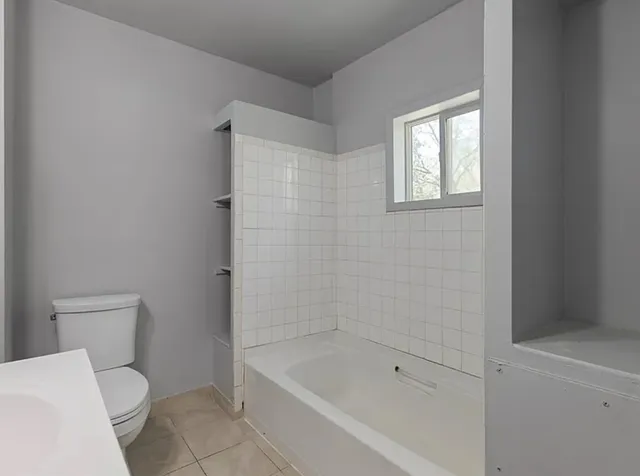a bathroom with a toilet and bathtub