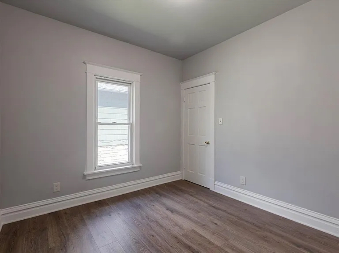 453 Water Street Joliet, IL 60436 - Photo 4 of 14 an empty room with wooden floor and window