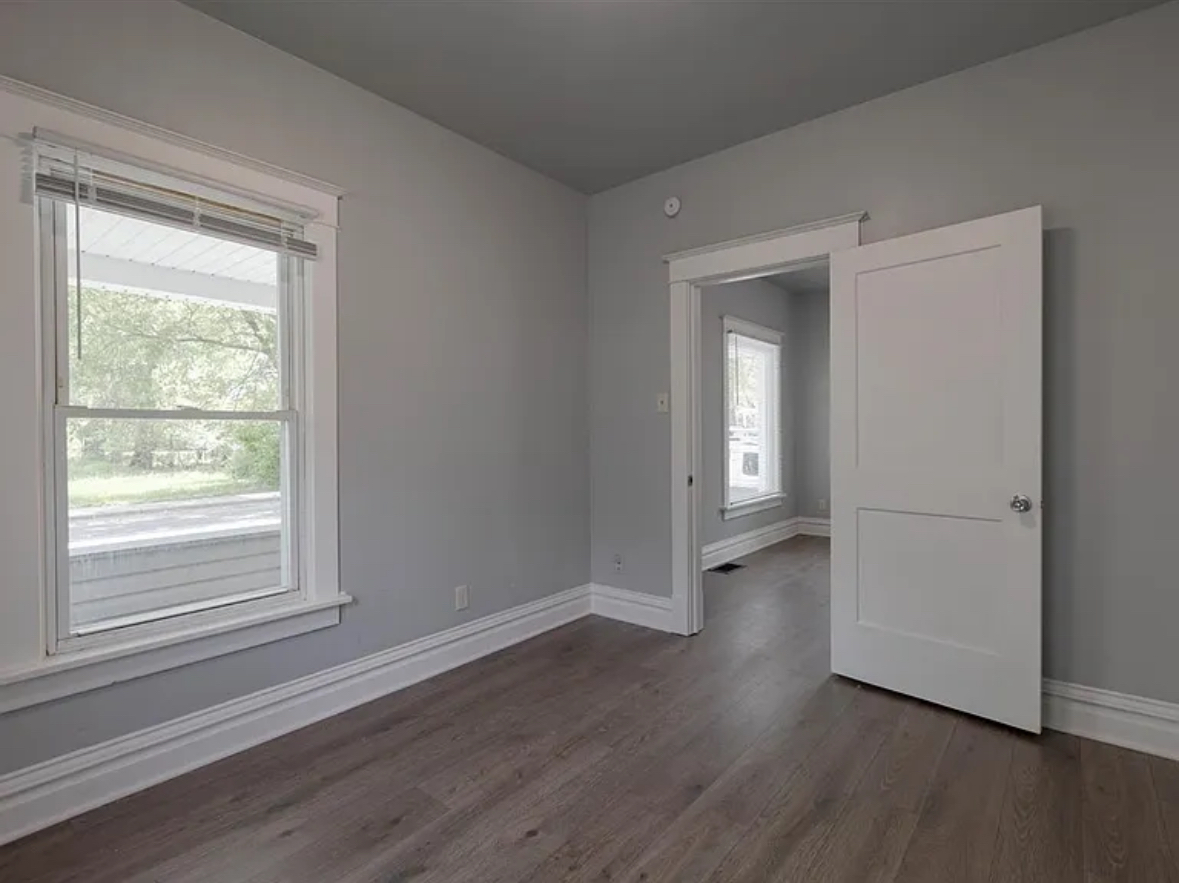 453 Water Street Joliet, IL 60436 - Photo 7 of 14 a view of an empty room with wooden floor and a window