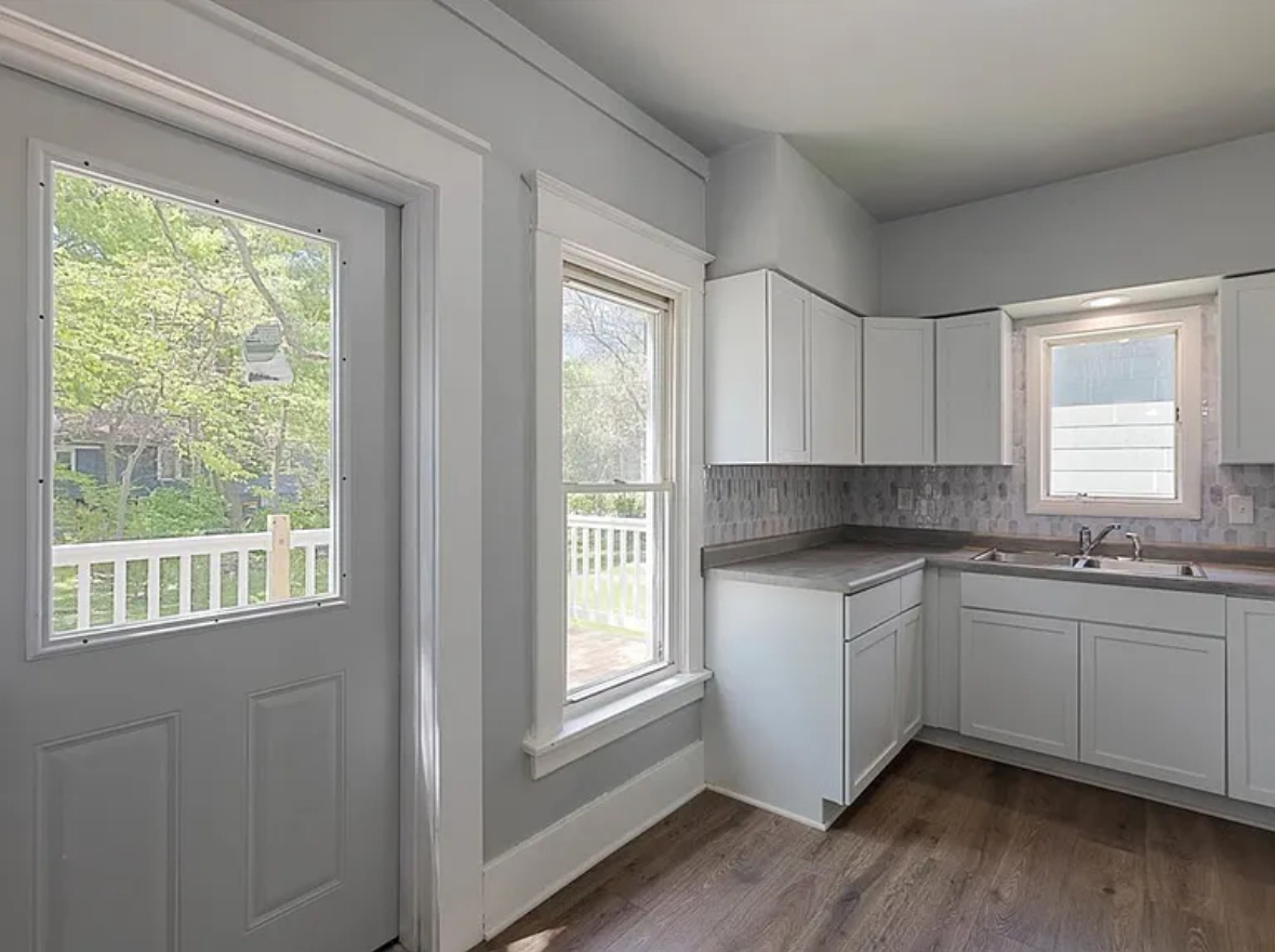 453 Water Street Joliet, IL 60436 - Photo 8 of 14 a kitchen with stainless steel appliances granite countertop white cabinets and wooden floor