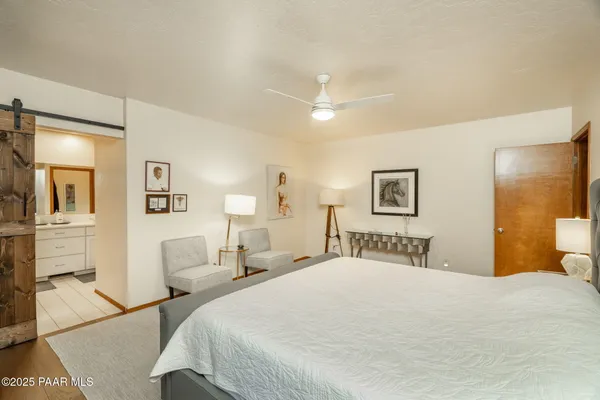 a bedroom with a bed and lamp with window