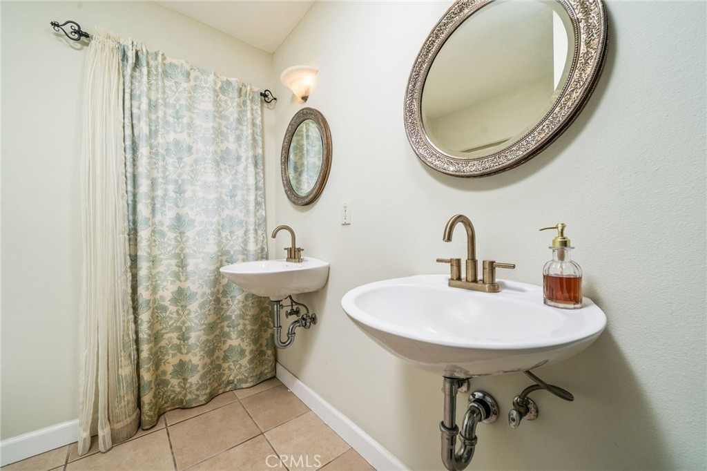 16639 Fox Glen Road Riverside, CA 92504 - Photo 31 of 153 a bathroom with a sink a mirror and a toilet