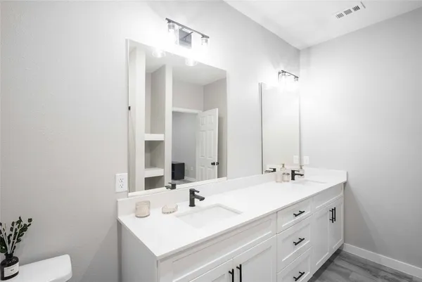a bathroom with a sink double vanity and a mirror