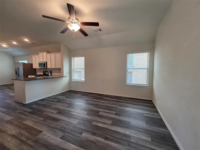 a view of a kitchen with microwave and cabinets