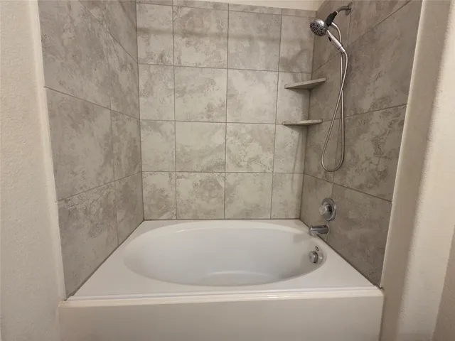 a bath tub sitting next to a shower