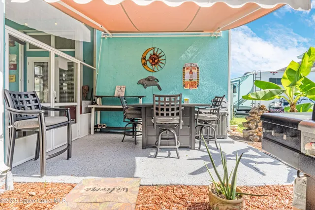 a view of an outdoor sitting area with furniture and backyard