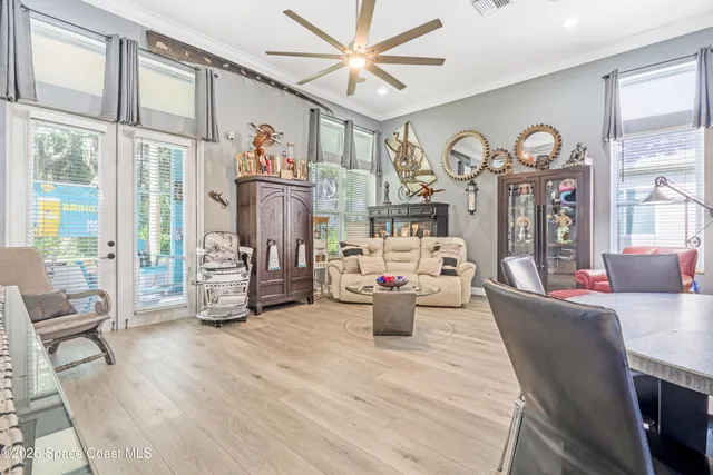 a living room with furniture a large window and a clock