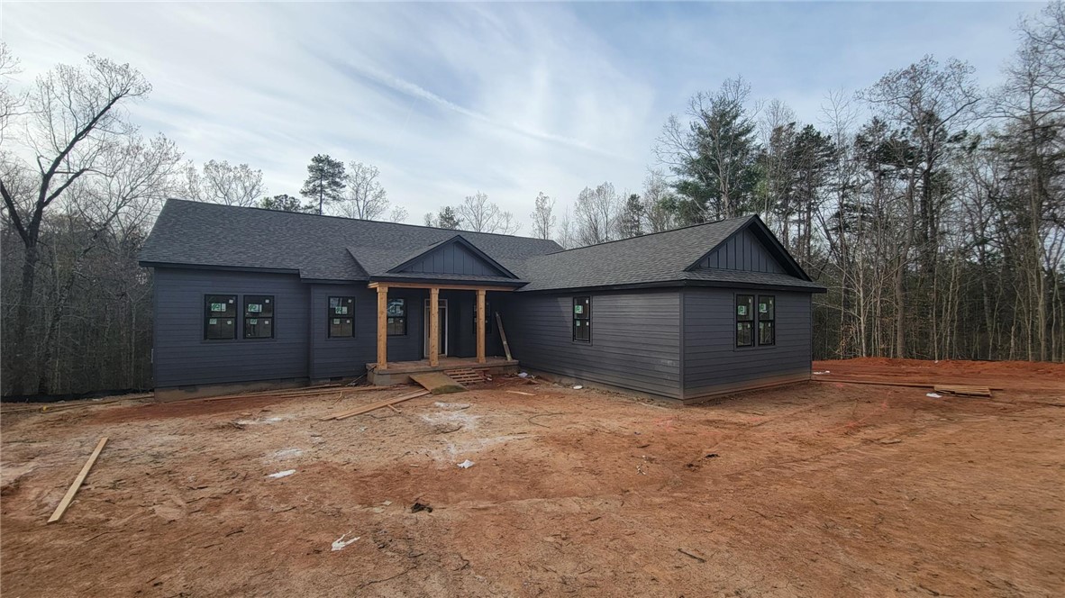 This new construction home presents a blend of modern design with natural surroundings.