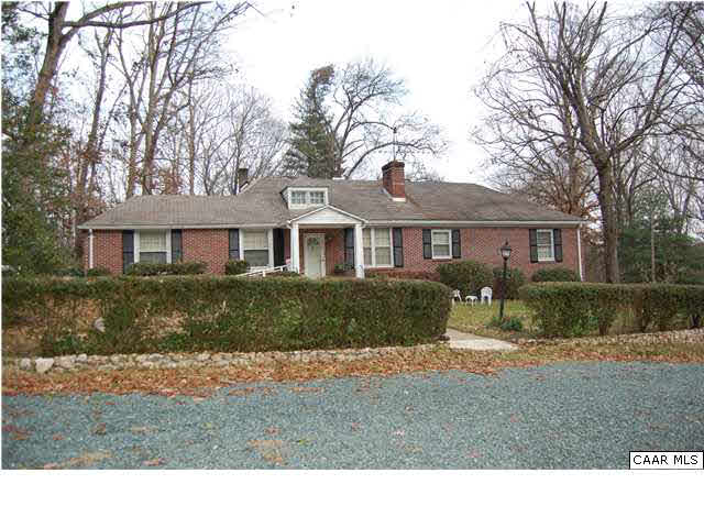 a black and white house with a yard