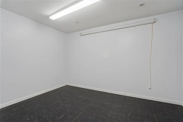 a kitchen with granite countertop a sink and cabinets