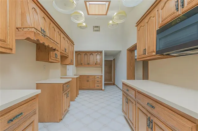a view of a kitchen with furniture and natural light