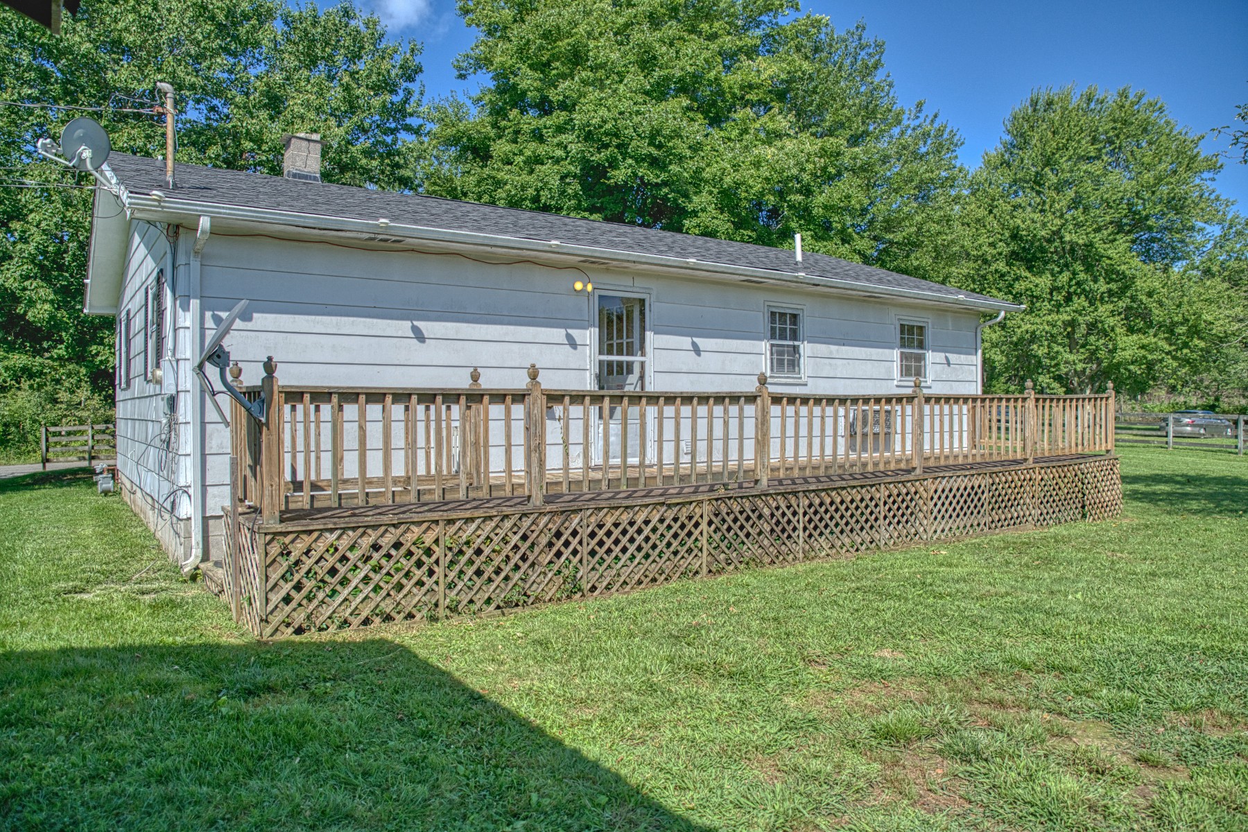 2110 Jr Camp Road Monterey, TN 38574 - Photo 15 of 35 a white house with a small yard and wooden fence