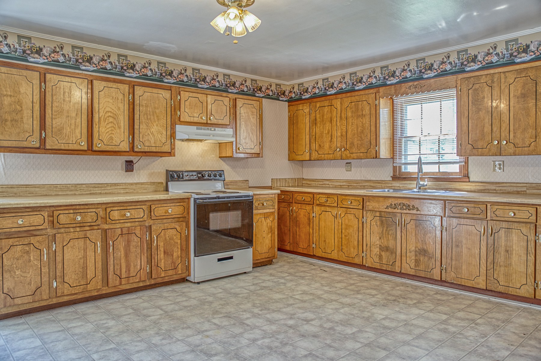 2110 Jr Camp Road Monterey, TN 38574 - Photo 25 of 35 a kitchen with cabinets a sink and white appliances