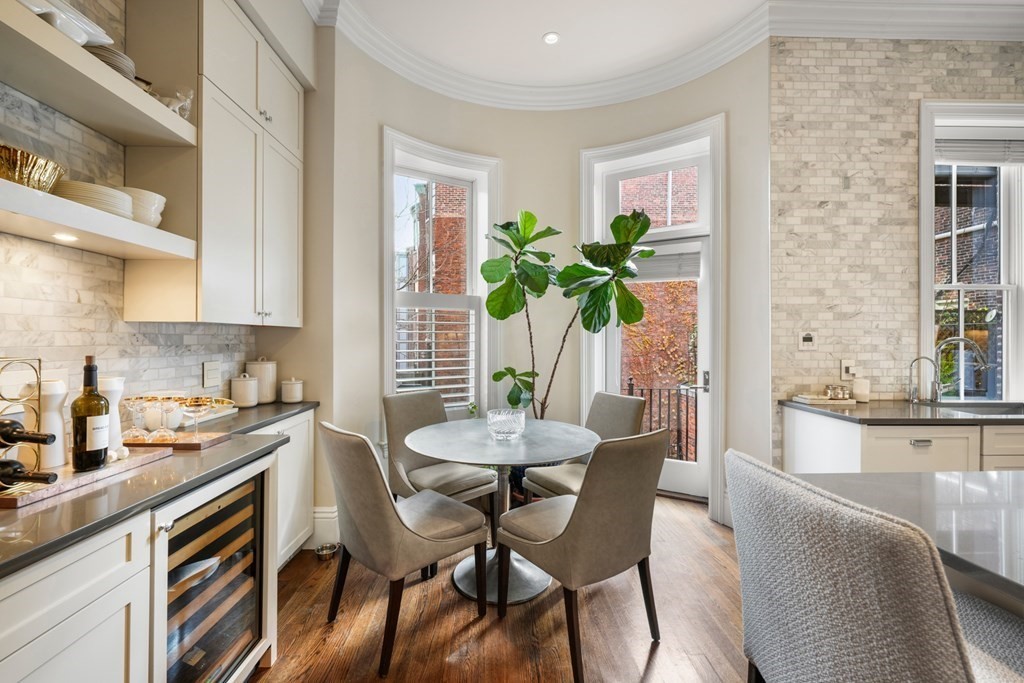 9 Columbus Square, Unit 2 Boston, MA 02116 - Photo 11 of 42 a dining room filled chandelier and wooden floor