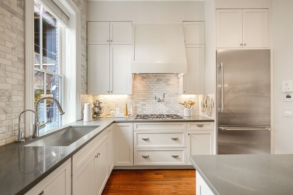 9 Columbus Square, Unit 2 Boston, MA 02116 - Photo 12 of 42 a kitchen with stainless steel appliances granite countertop a refrigerator and a sink