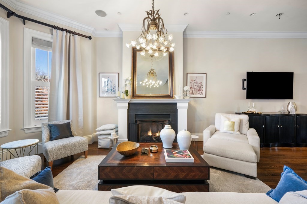 9 Columbus Square, Unit 2 Boston, MA 02116 - Photo 2 of 42 a living room with furniture a chandelier and a fireplace