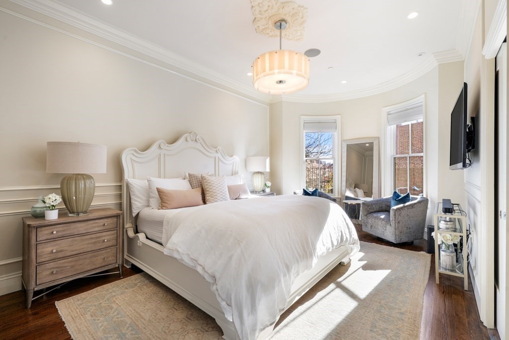9 Columbus Square, Unit 2 Boston, MA 02116 - Photo 26 of 42 a bedroom with bed and a chandelier