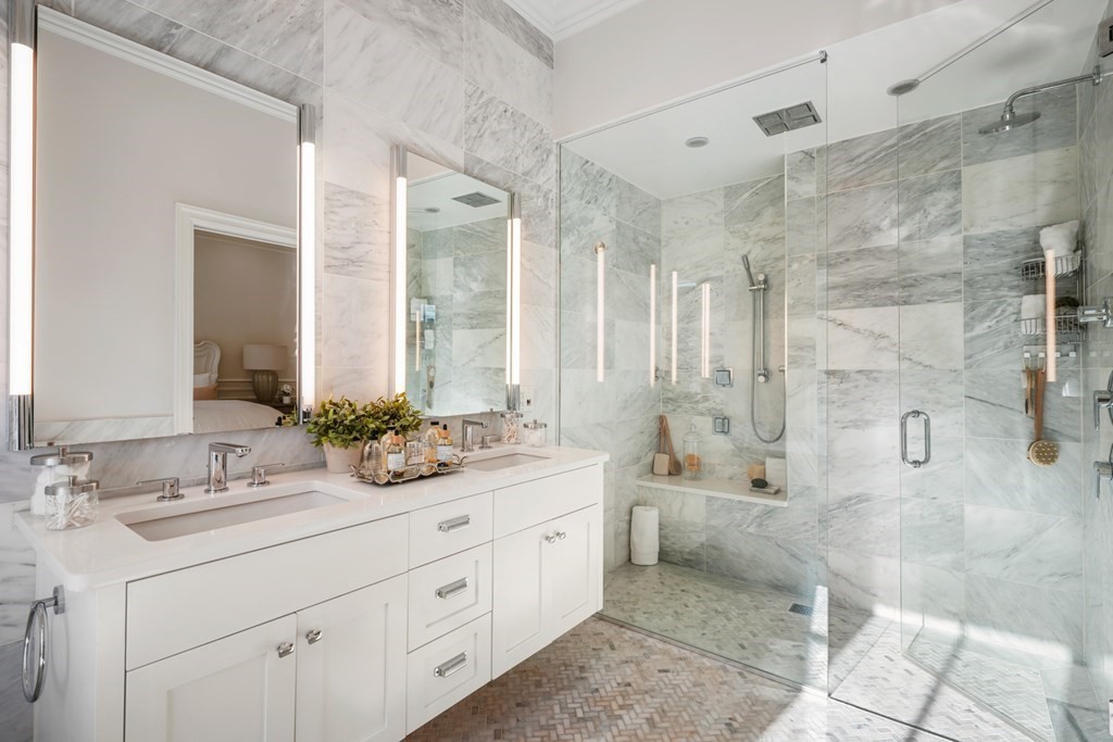 9 Columbus Square, Unit 2 Boston, MA 02116 - Photo 29 of 42 a spacious bathroom with a double vanity sink toilet mirror and bathtub