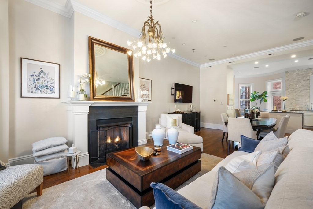 9 Columbus Square, Unit 2 Boston, MA 02116 - Photo 3 of 42 a living room with furniture a fireplace and a chandelier