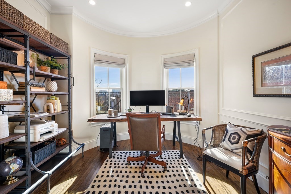 9 Columbus Square, Unit 2 Boston, MA 02116 - Photo 36 of 42 a living room with furniture a flat screen tv and a bookshelf