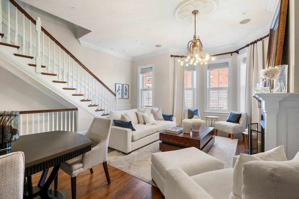 9 Columbus Square, Unit 2 Boston, MA 02116 - Photo 4 of 42 a living room with furniture a chandelier and a large window