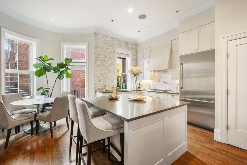 9 Columbus Square, Unit 2 Boston, MA 02116 - Photo 8 of 42 a kitchen with appliances cabinets dining table and chairs