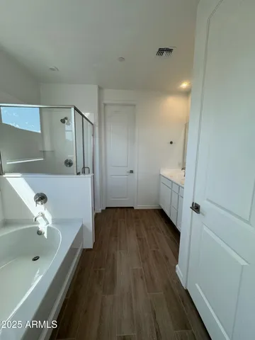 a bathroom with a bathtub and a sink
